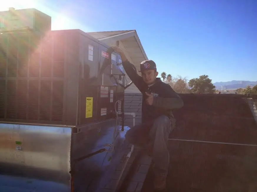 HVAC technician performing Boiler Repair on a rooftop unit in Sweetwater